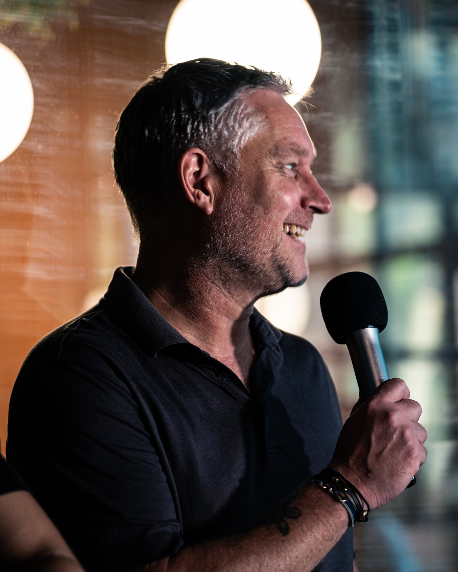 David Dwinger speaking into a microphone